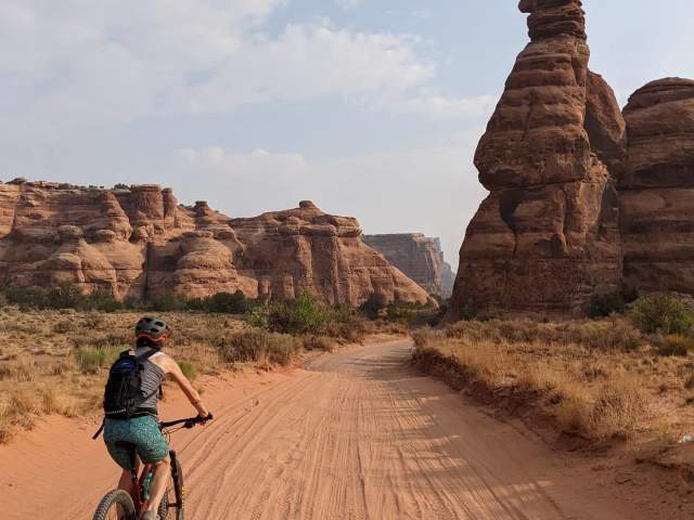 man cycling on a dirt road