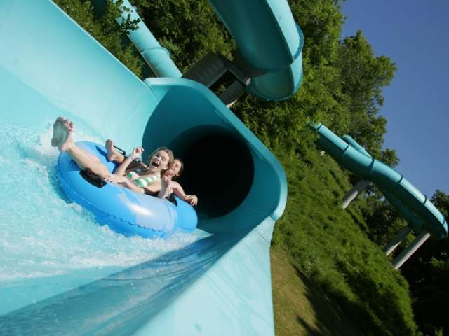 Young children on a water slide at Lake Raystown Resort's Wild River Waterpark