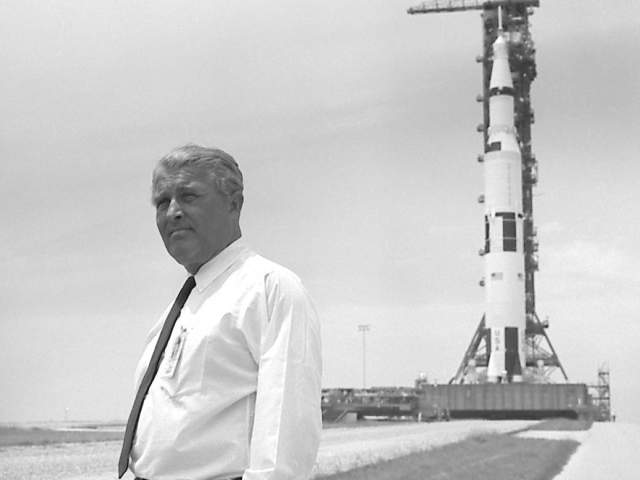 Dr. Wernher von Braun pauses in front of the Saturn V vehicle being readied for the historic Apollo 11 lunar landing mission. The Saturn V vehicle was developed by the Marshall Space Flight Center in Huntsville, Alabama under the direction of von Braun.