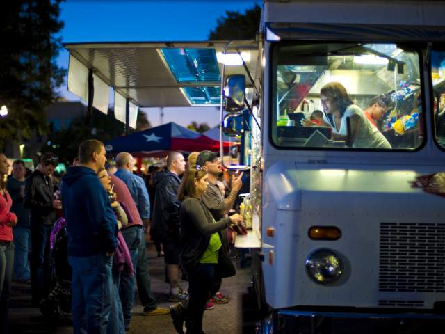 Patrons order from a food truck in Huntsville, AL