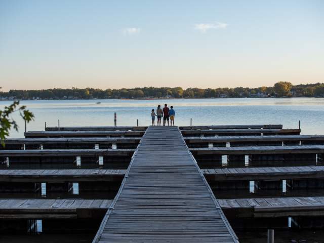 A family standing at the end of the pier at Pokagon State Park