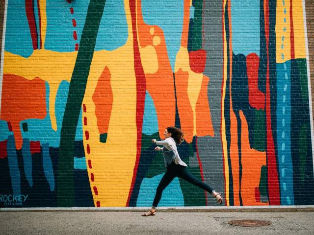 Woman in front a mural