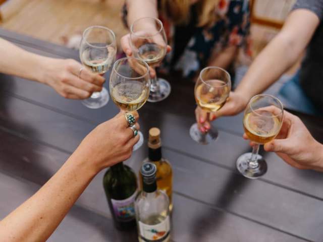 Hands holding wine glasses