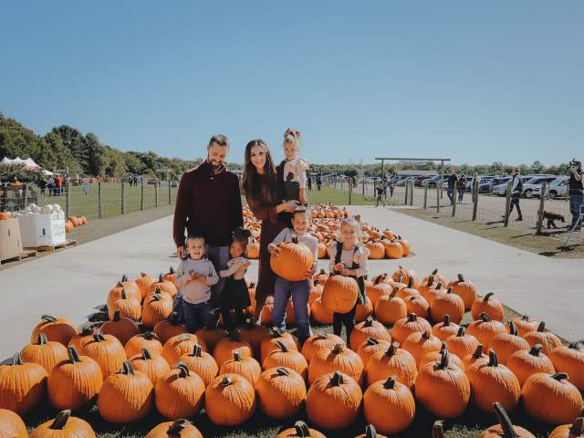 Family posing at pumpkin patch