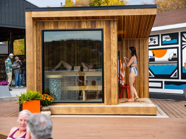 people sauna and sit outside to cool in this community sauna space