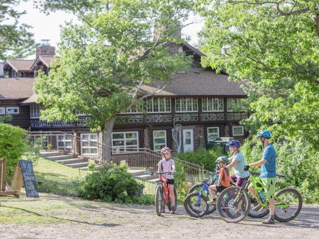Family preparing for bike ride in front of Keweenaw Mountain Lodge