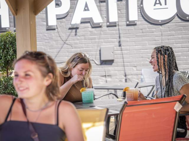 Girls sitting at Gino's patio having a drink.