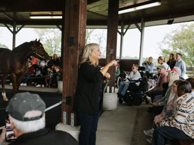 Woman signing to crowd at KY Horse Park