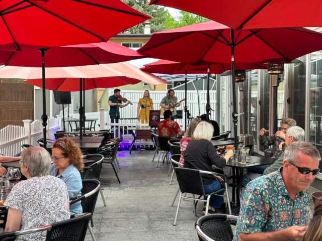 Patio with people dining and live music