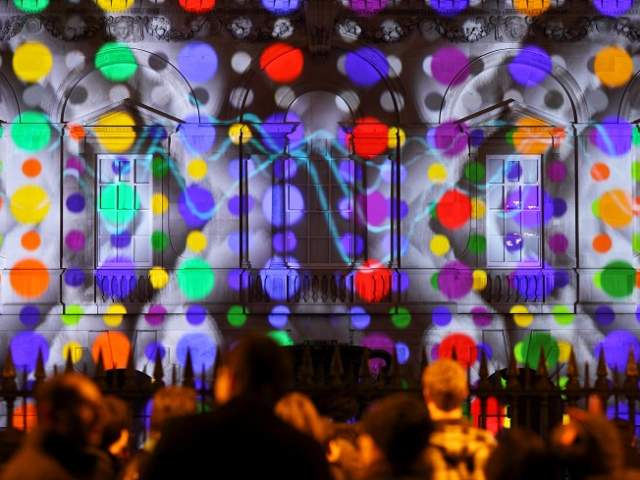 The Senate House, Cambridge light up with a digital projection in bright spotlights