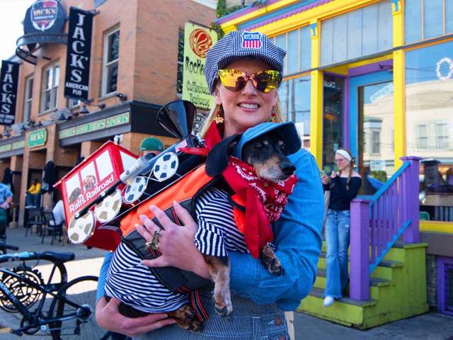 Woman holding her dog at the Brady Street Pet Parade