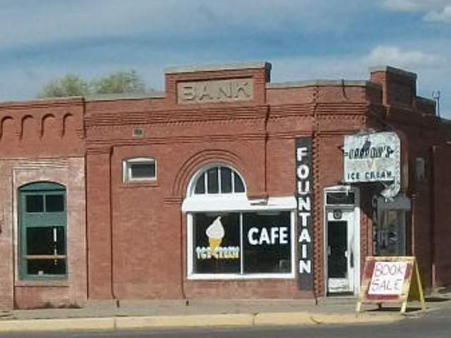 The corner café in Magdalena, NM with signs for ice cream and a book sale