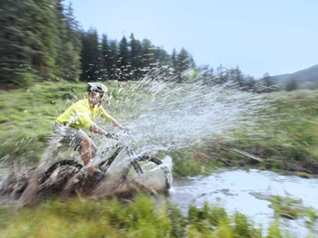 Splashing into water on a mountain bike in New Mexico