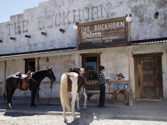 Horses and riders in front of the Buckhorn Saloon in Pinos Altos, NM