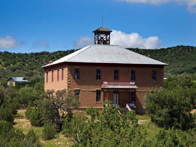 A brick building with bell tower in White Oaks, NM
