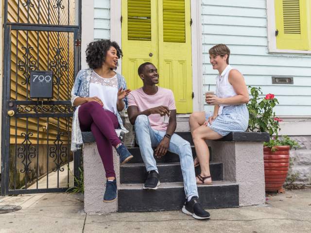 Friends sitting on a porch, talking