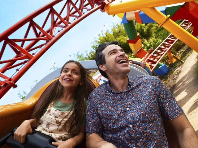 A father and daughter on the Slinky Dog Dash rollercoaster at Toy Story Land in the Magic Kingdom at Walt Disney World Resort