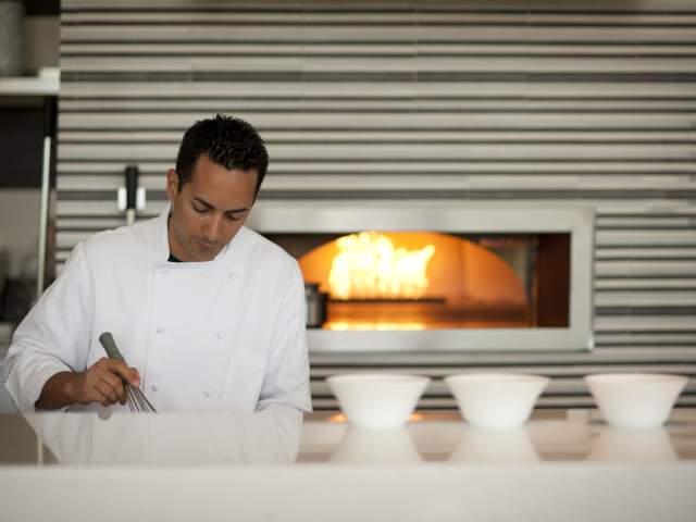 A chef in front of a pizza oven at La Luce italian restaurant at the Hilton Orlando Bonnet Creek