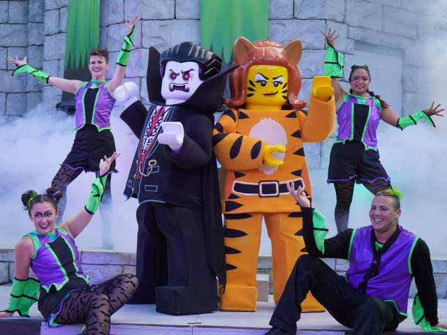 LEGO characters and dancers pose onstage at the VIM Dance Party, part of Brick-or-Treat Presents Monster Party at LEGOLAND Florida Resort