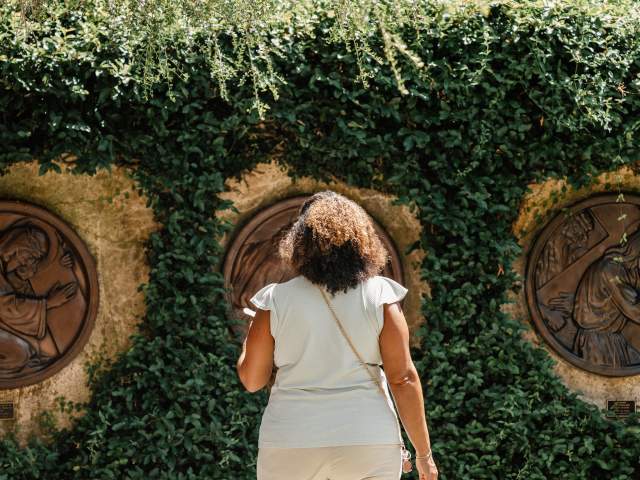 A woman views outdoor sculpture at the Albin Polasek Museum & Sculpture Gardens.