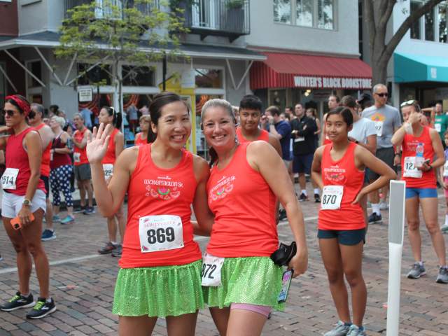 Two women smile at the staring line for the AdventHealth Watermelon 5K in Winter Park