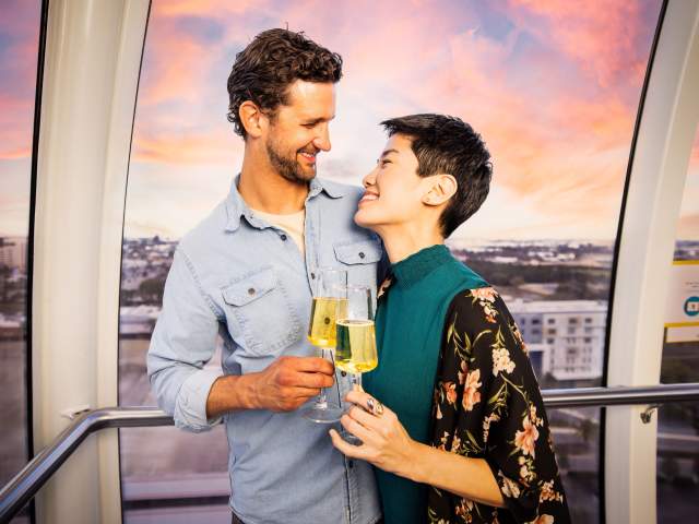 A couple with champagne at The Orlando Eye at ICON Park®