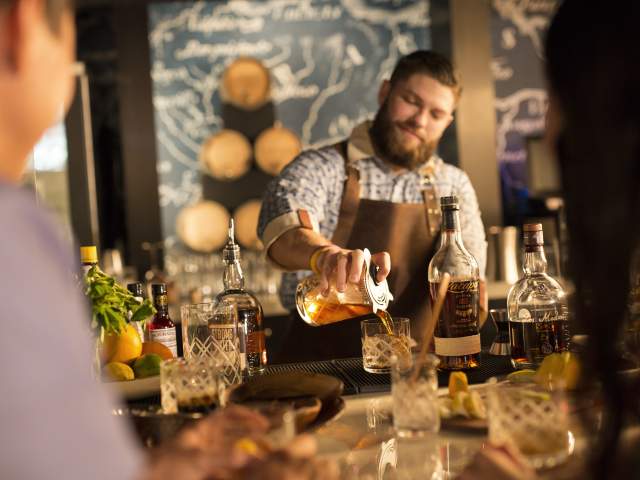 Loews Sapphire Falls Resort at Universal Orlando™ bartender pouring drink at Strong Water Tavern