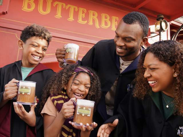 Family enjoying Butterbeer in The Wizarding World of Harry Potter at Universal Orlando Resort