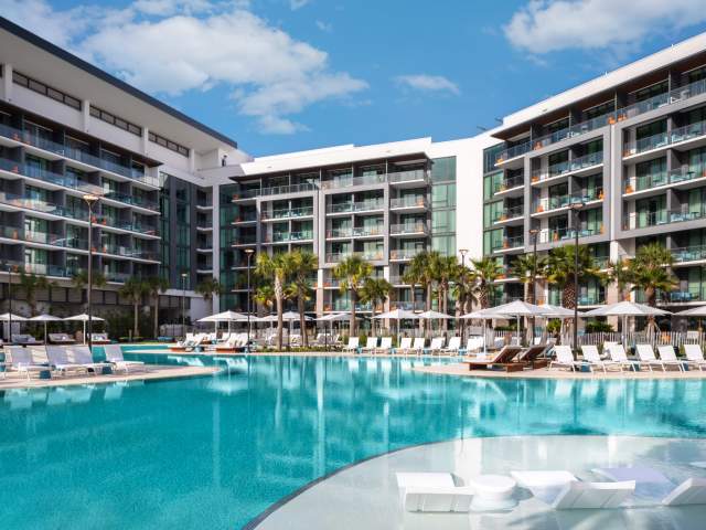 View of pool and hotel exterior at Conrad Orlando