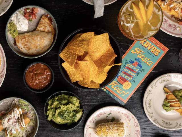 Select happy hour items at Kavas Tacos + Tequila Orlando, including chips and guac, salsa, chicken flautas, a mini cheese quesadilla, grilled street corn and a black bean empanada