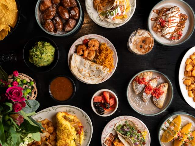 Overhead shot of brunch dishes like omelets, tacos and cocktails at Kavas Tacos + Tequila Orlando