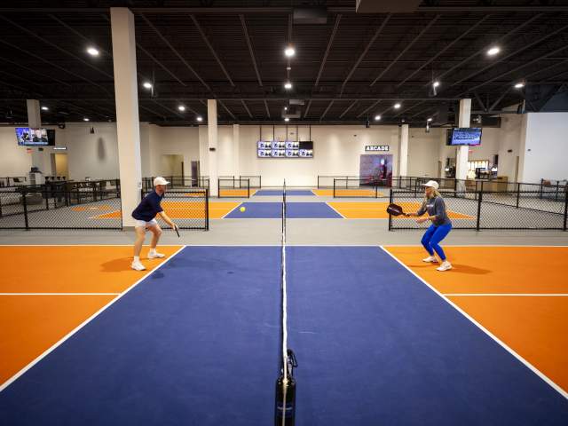 Anna Cooke, director of marketing, faces off against Evan Addington, director of pickleball, at Crush Yard Orlando, a 48,000-square-foot facility that recently opened in Kissimmee on Jan. 14, 2025. (Patrick Connolly/Orlando Sentinel)