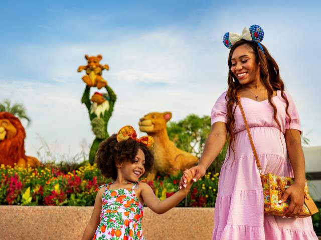 A woman and young girl walk in front of topiaries at the EPCOT International Flower & Garden Festival, held annually at Walt Disney World Resort in Orlando.