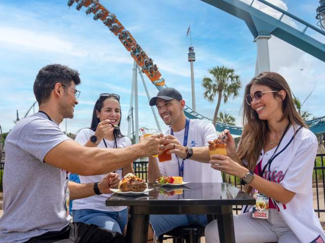 Two couples enjoy food and beverages at SeaWorld Orlando's Red, White & BBQ event.