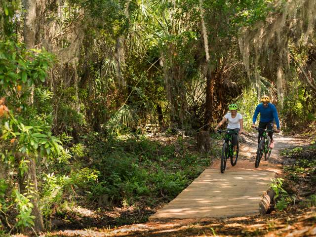 Couple riding bicycles at JW Marriott Orlando, Grande Lakes