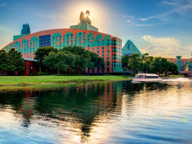 Walt Disney World Swan and Dolphin Resort exterior with boat at dusk