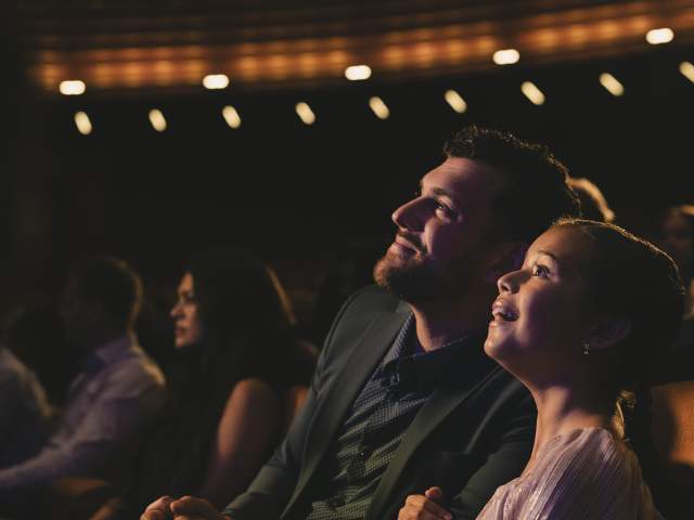 A father and daughter enjoy a show at Steinmetz theater