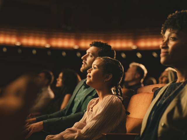 A father and daughter enjoy a show at Steinmetz theater