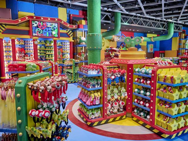 Colorful NINTENDO-themed toys, accessories, home goods and more fill the shelves in an interior shot of 1-UP Factory at Universal Epic Universe