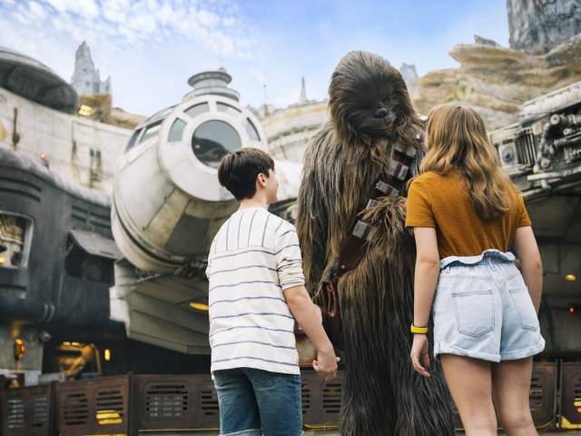 Kids meeting Chewbacca in Star Wars: Galaxy's Edge at Disney's Hollywood Studios in the Walt Disney World Resort.