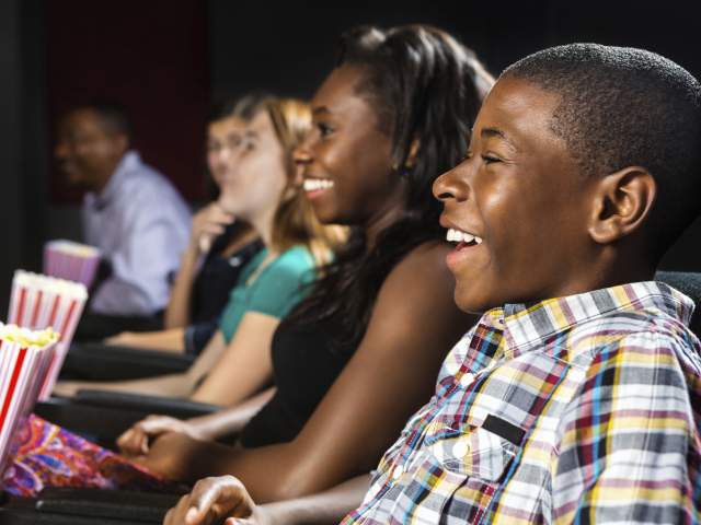 Teens watching a film at a movie theater