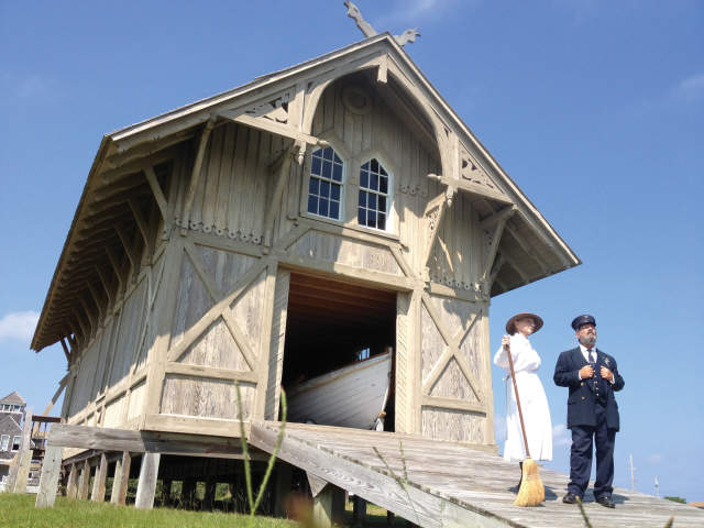 Two People In costume standing in front of a raised building