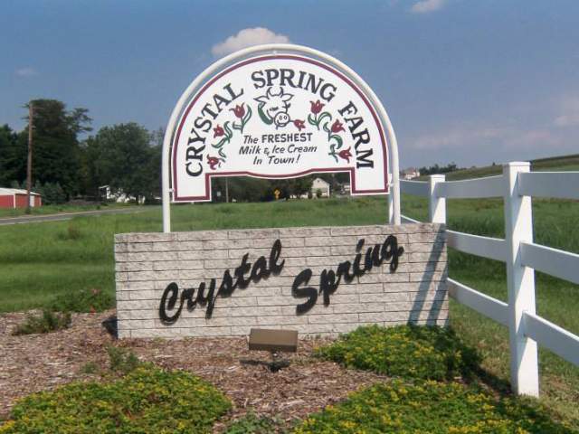 Signage outside of a farm that reads Crystal Spring Farm