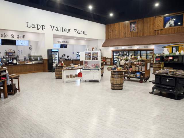 Interior of an ice cream parlor with signage that reads Lapp Valley Farm above a check out counter