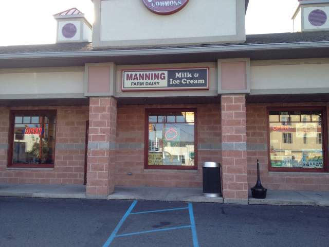 Exterior of a storefront in an outdoor mall that reads Manning Farm Dairy Milk & Ice Cream