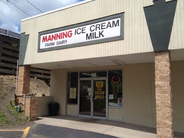 Exterior of a storefront with the signage Manning Farm Dairy Ice Cream Milk