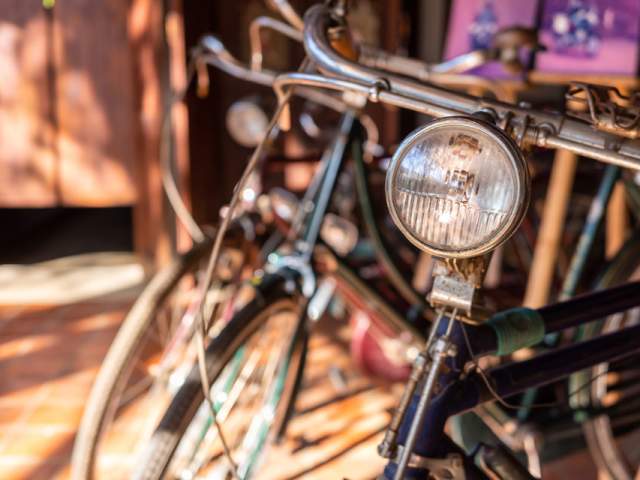 Row of old bicycle with large flashlights on the front
