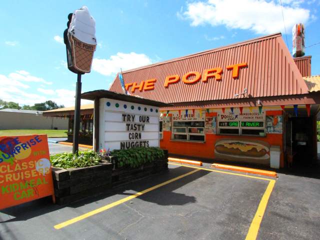 An orange and brown building with the words "The Port" on the room. An ice cream cone sign is out in front.