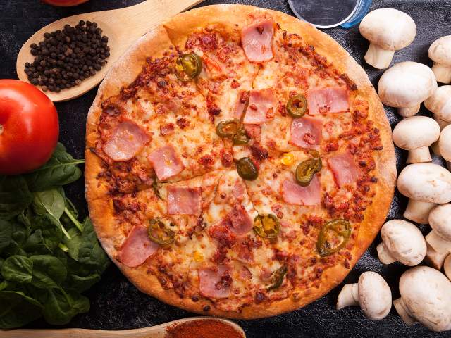 Pizza with mushroom, basil, and tomatoes