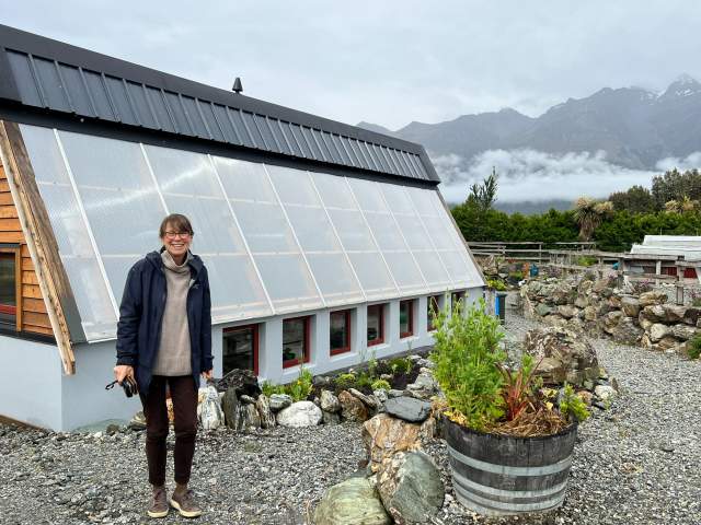 Headwaters Eco-Lodge founder Debbi Brainerd in front of the winterised greenhouse which is built over 3.5 metres into the ground.